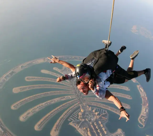 Skok ze spadochronem nad Palm Jumeirah w Zjednoczonych Emiratach Arabskich. Widok z lotu ptaka na sztuczną wyspę.